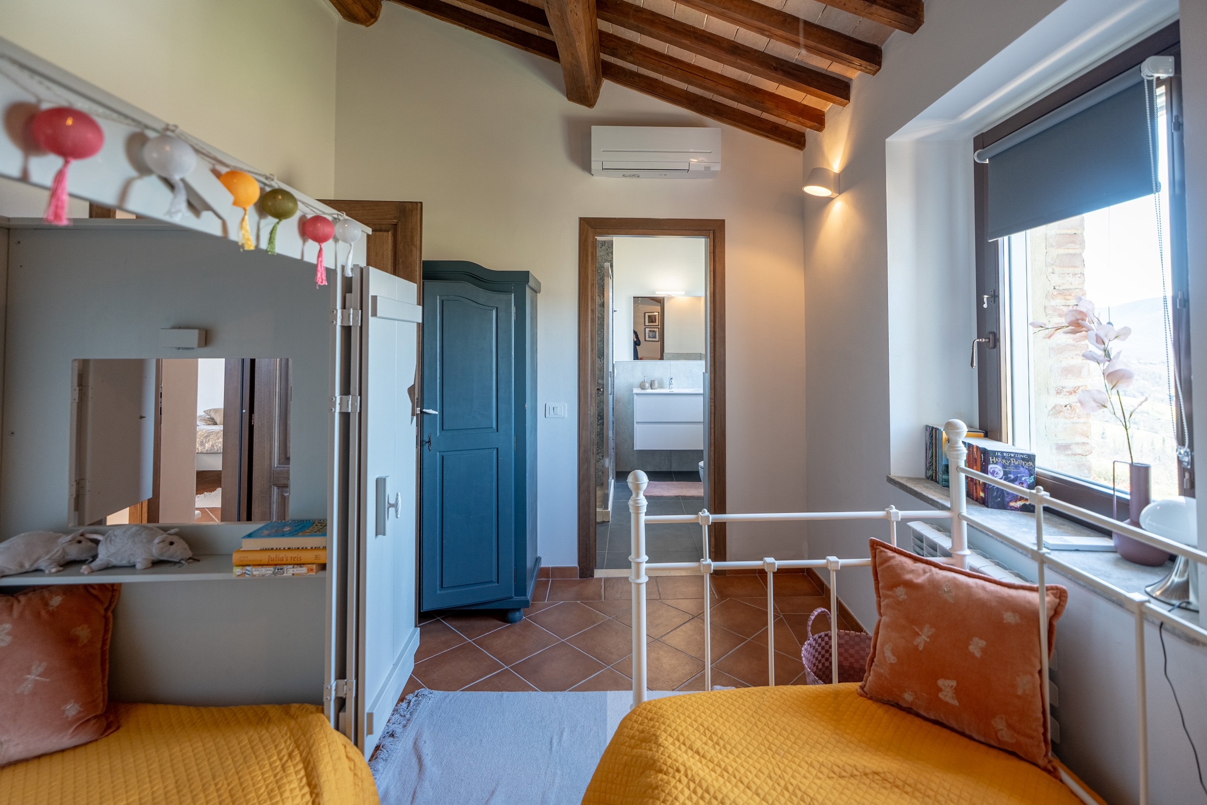 Children's twin bedroom with colourful decor and en-suite